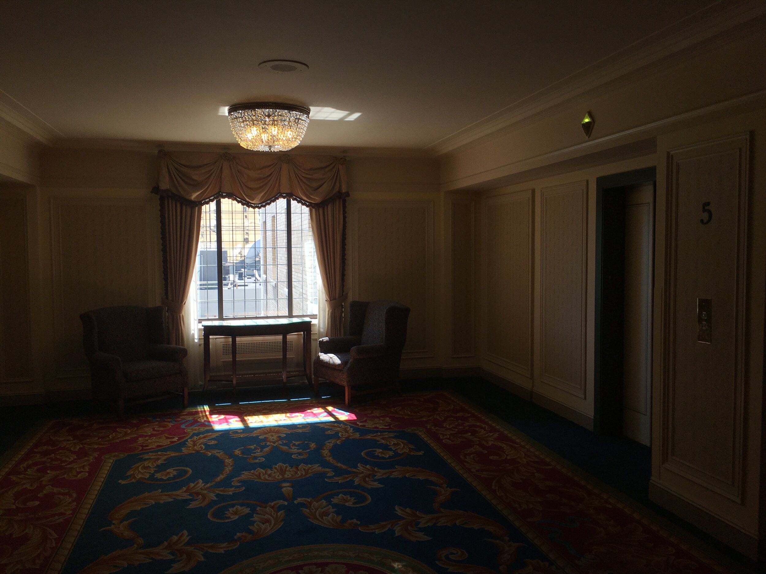 5th floor elevator entrance–noticeably outdated compared to the lobby.